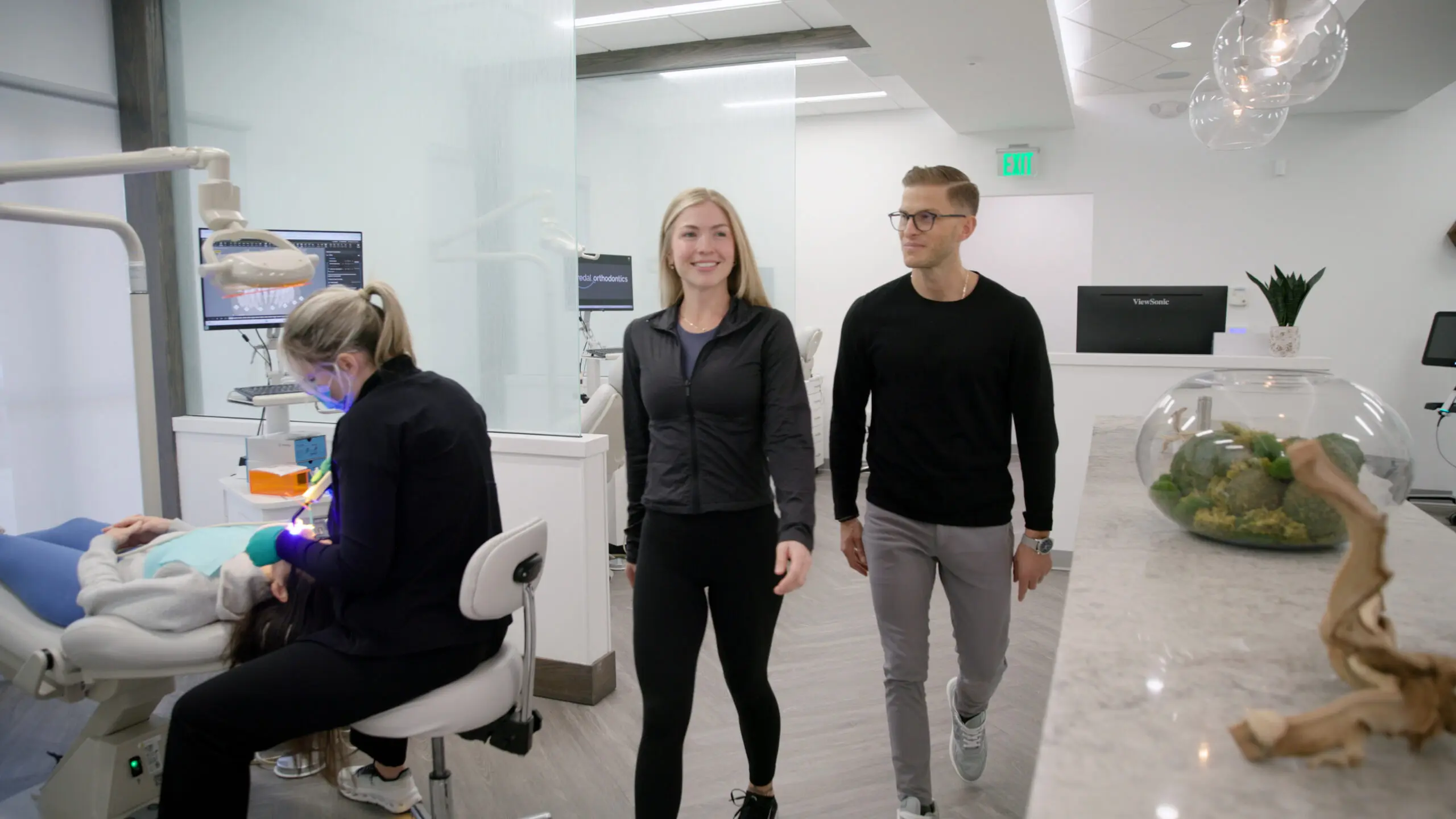 Dr. Fredal and patient walking in modern office